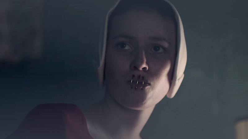 A handmaid shows June why she’s unable to speak.